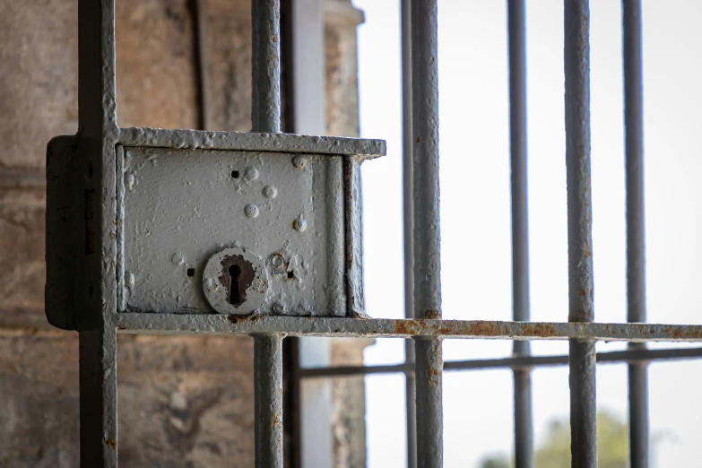 an old looking  cell door and the bars