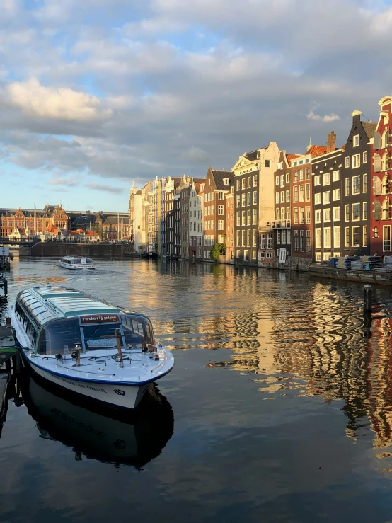 two boats docked along side the water