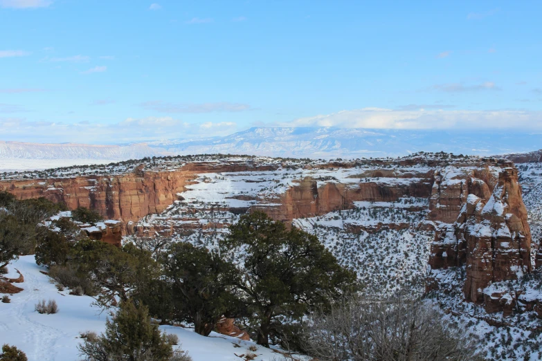 some snow a very tall cliffs and mountains