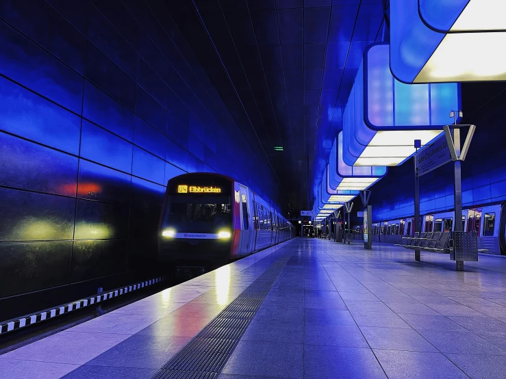 a train traveling down the tracks in a terminal