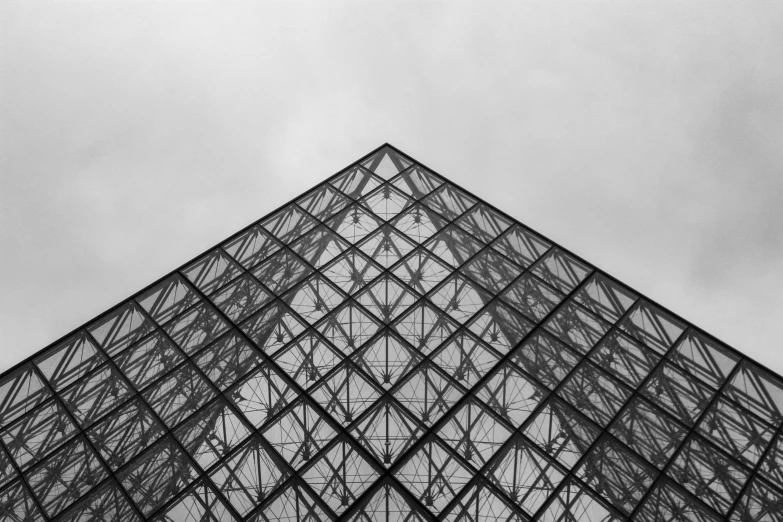 black and white pograph of the inside of a glass pyramid