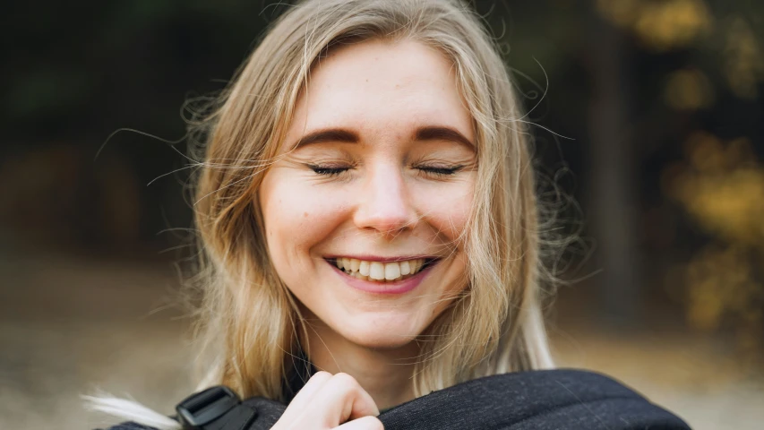 the woman with the beautiful smile on her face is smiling