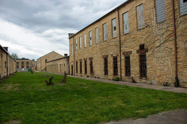 some buildings near some grass on a cloudy day