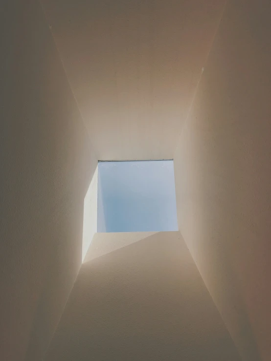 a rectangular hole in the ceiling where light is coming from