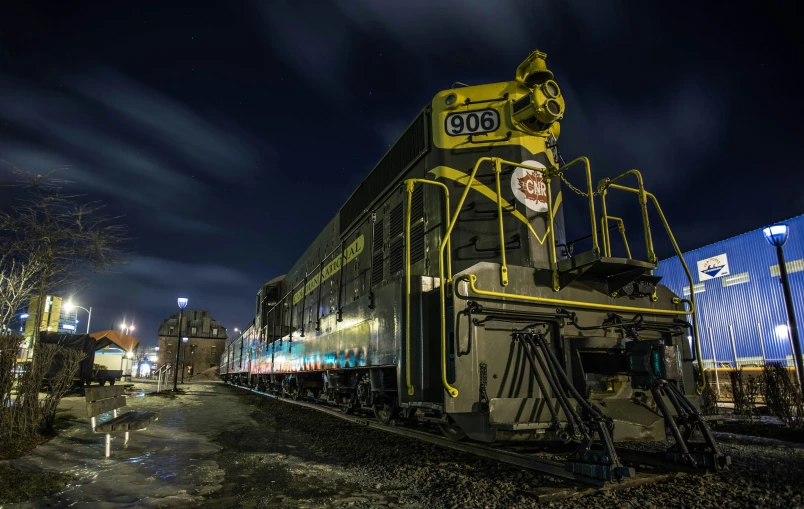 a train sitting on the tracks in front of a building