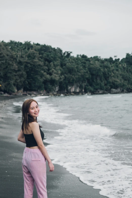 there is a woman that is standing on the beach