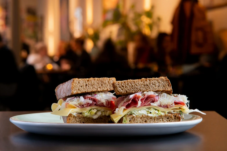 a plate of meat, lettuce and cheese sandwich