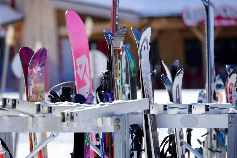 some snow boards are attached to a rack