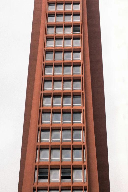 a tall red building with lots of windows