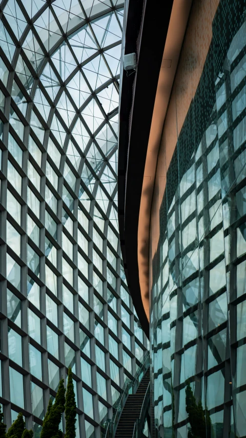 the building has a large glass roof over the staircase