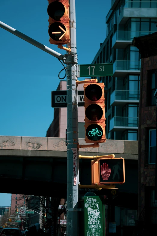 a stop light, street signs and street light on a pole