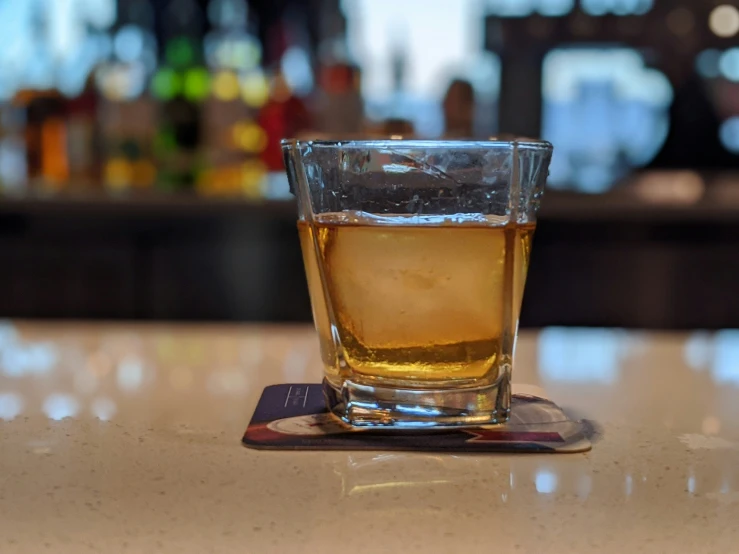 a glass with a beverage on the table