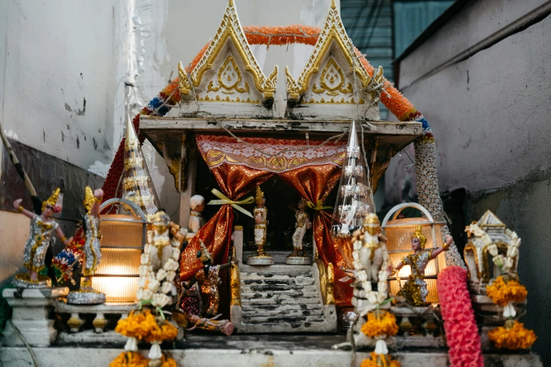 an idol is adorned with golden and red decorations