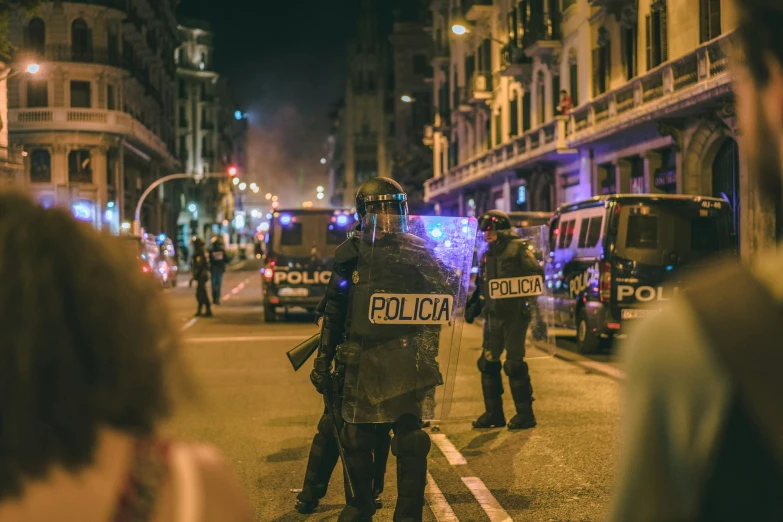 police standing on a city street at night