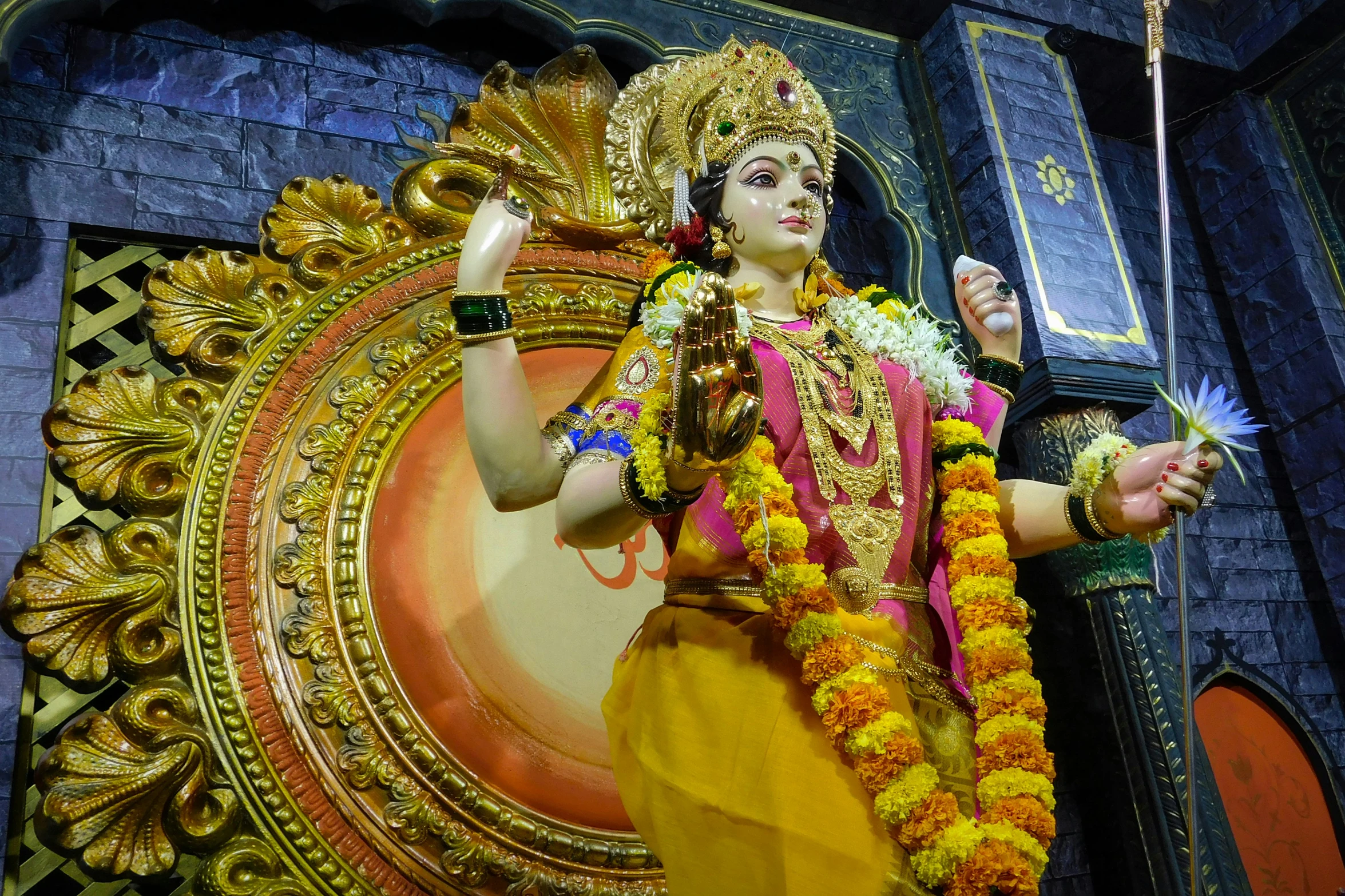 a statue depicting the god person, made of yellow flowers