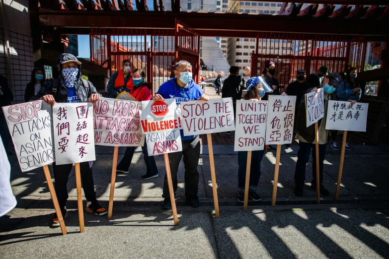 a group of protesters outside of a caged area