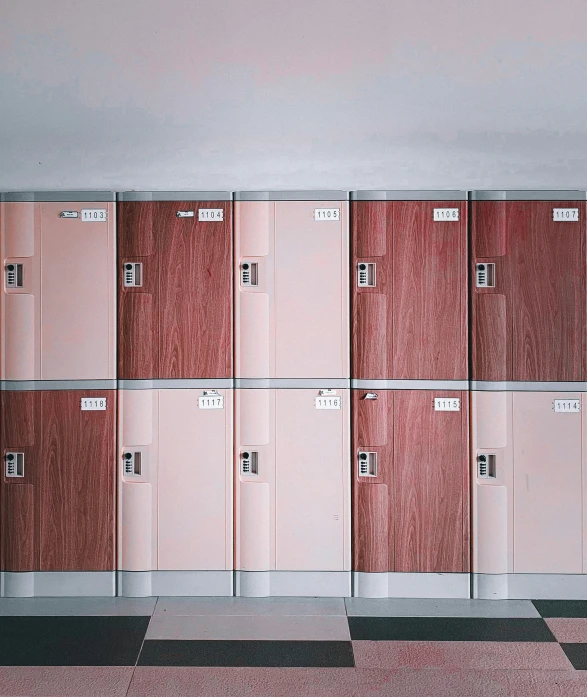 a wall of lockers and benches are lined up against a wall