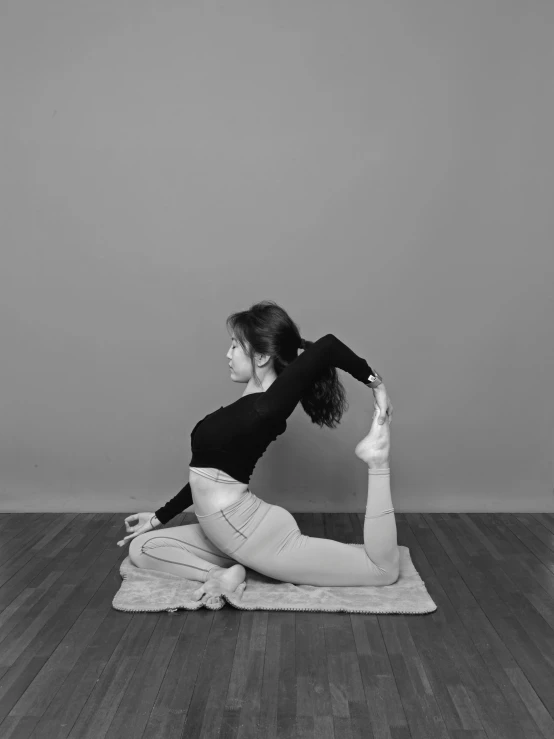 a woman in a pose on top of a towel