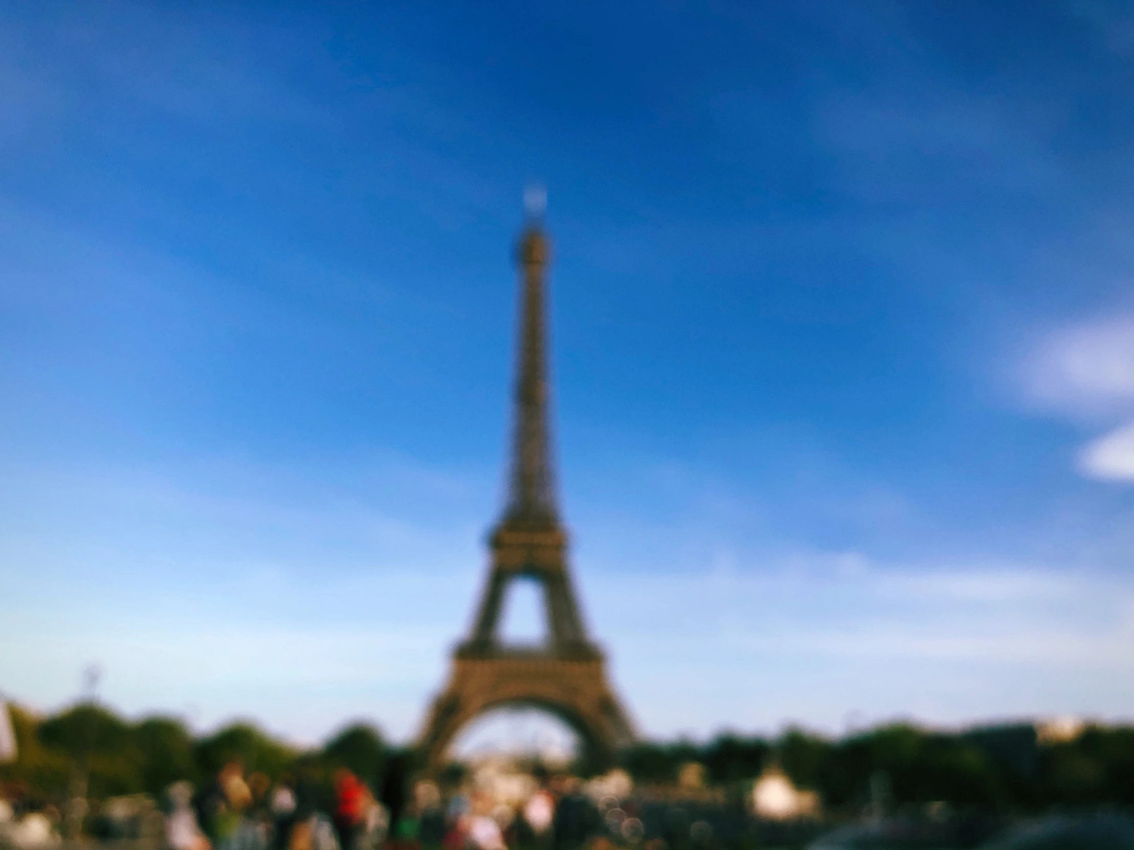 a blurry picture of people in front of the eiffel tower