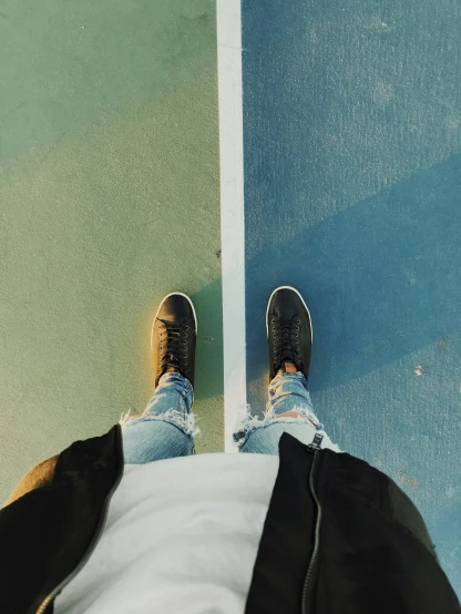 a view of someone's feet with sneakers on