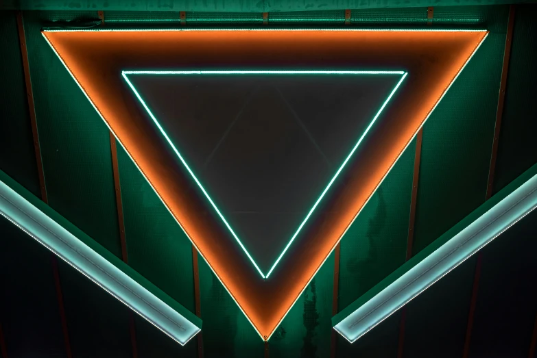 a very large green triangle lit up with white lights