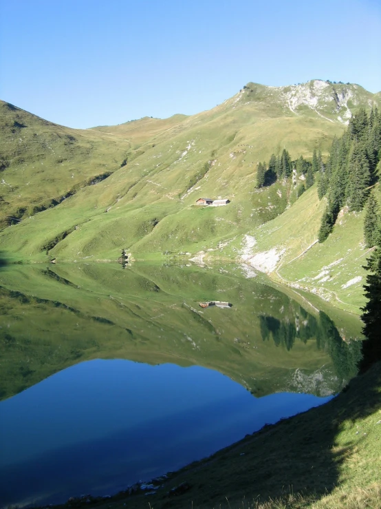 a lake in the middle of a green valley