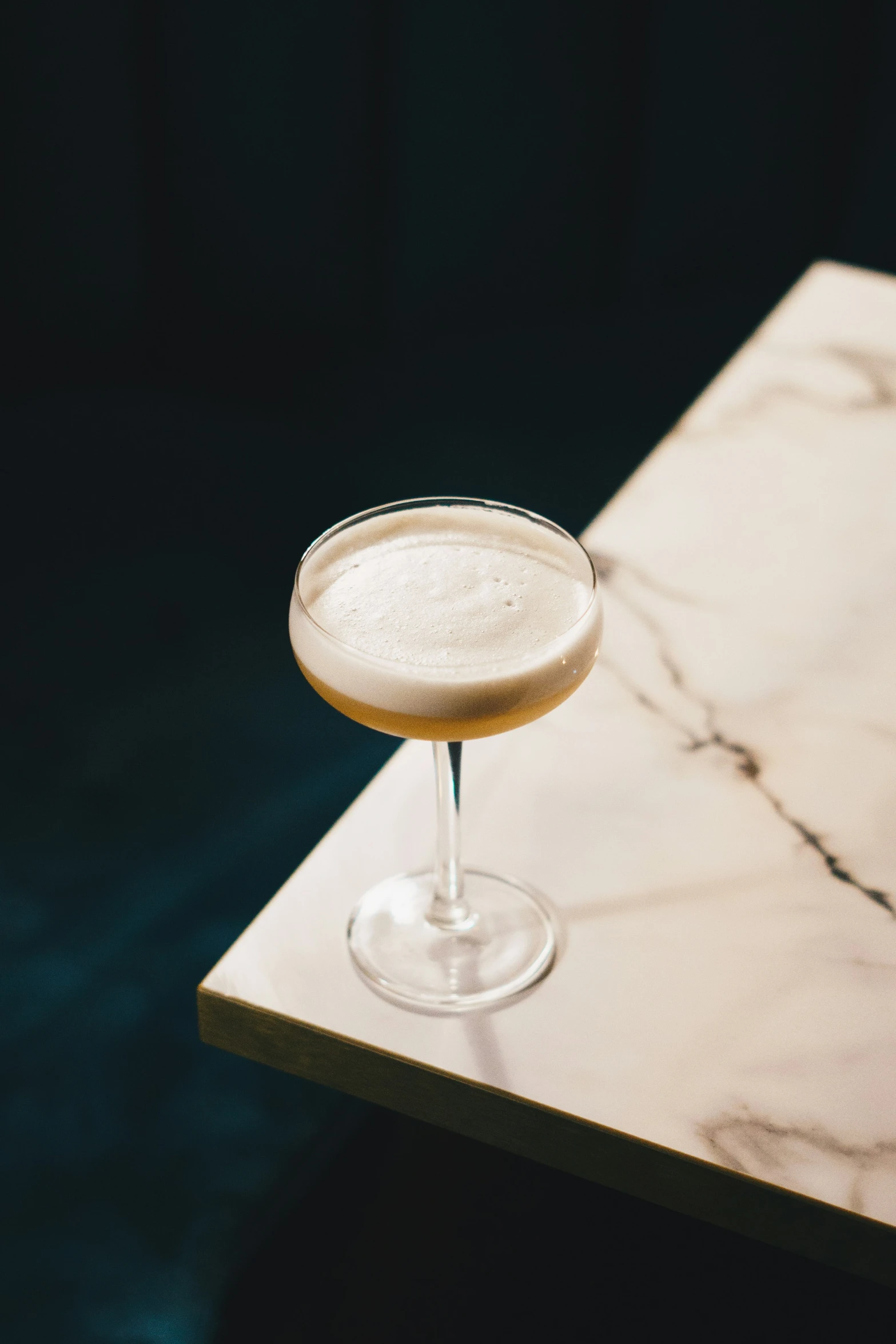 a drink is sitting in a glass on top of a table