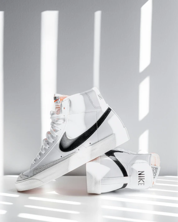 the nike air force 1 hi is white and black with orange accents