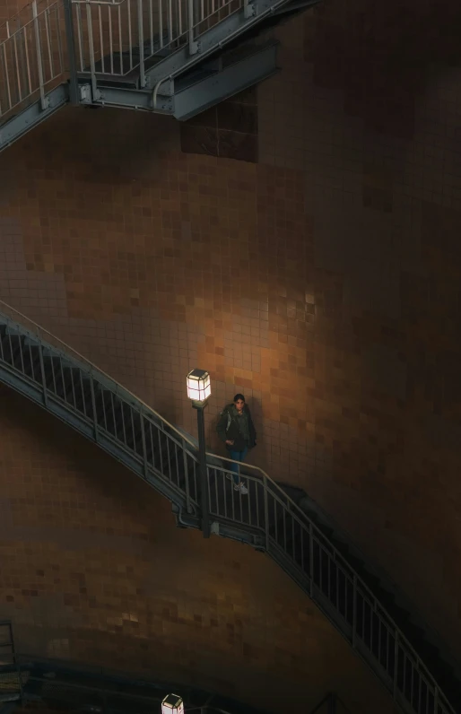 a man walking down the stairs next to a stairwell