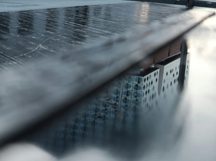 a building is reflected in the surface of the water