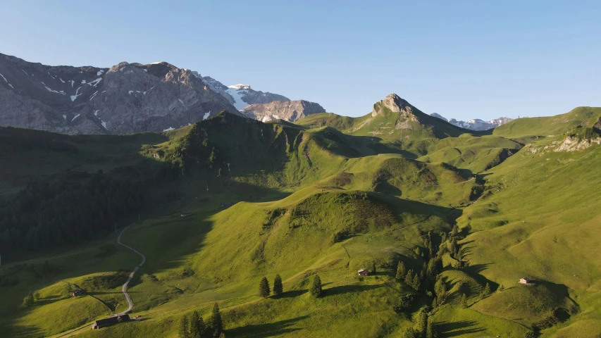 a grassy area with some mountains in the background