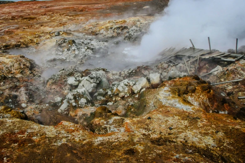 steam rises from the ground with rocks and boulders