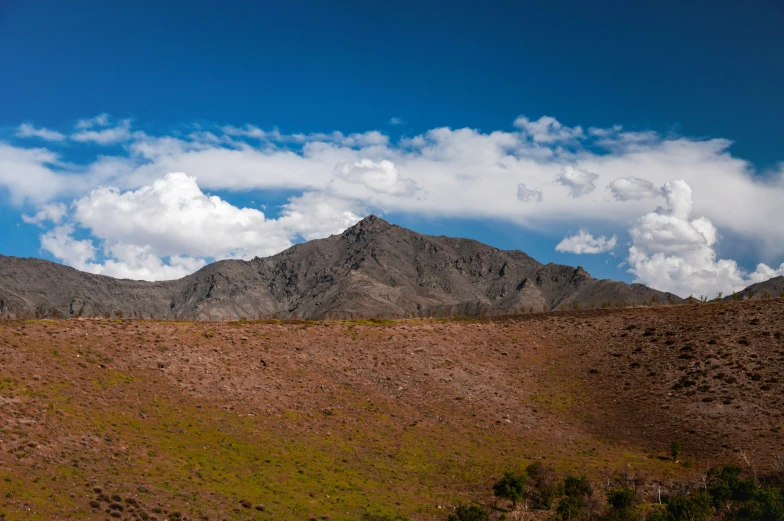 the mountains are high in the sky and are brown