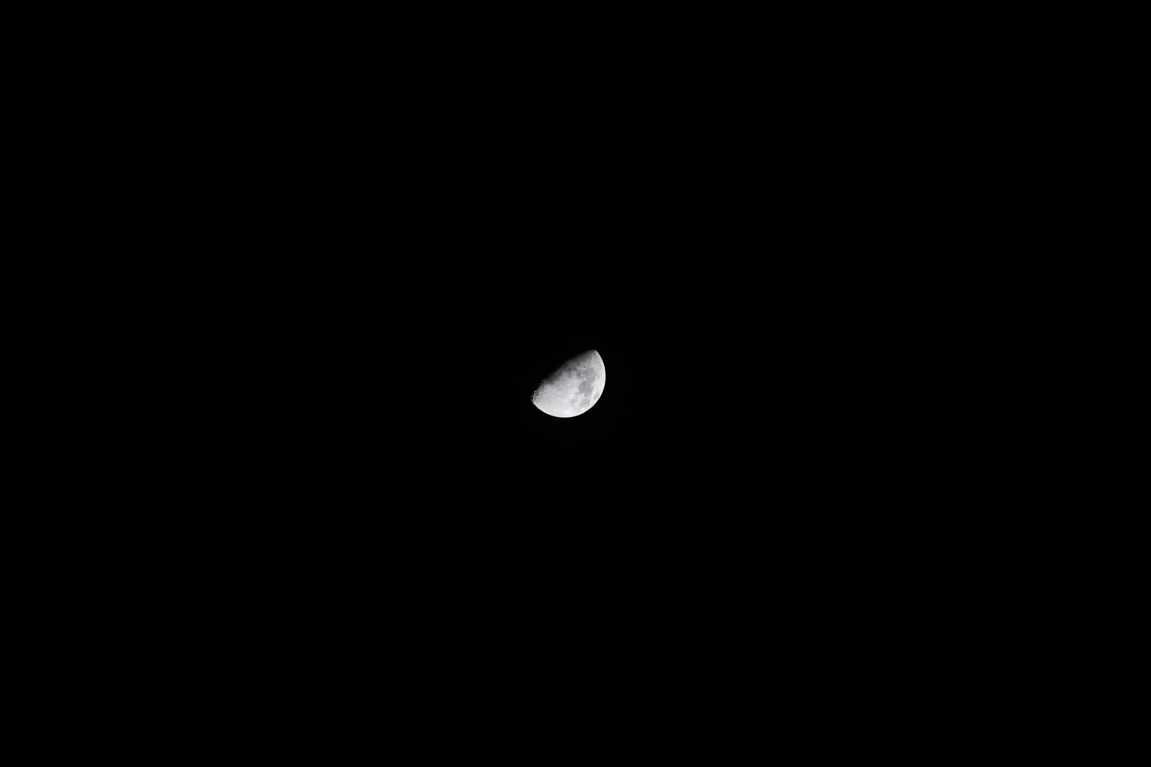 a half moon with a dark background