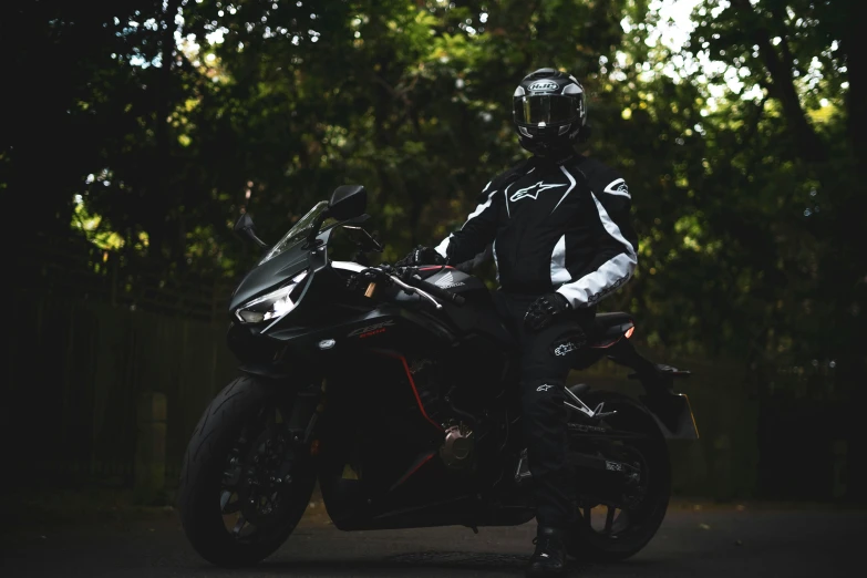 a man sitting on a motorcycle and posing for the camera