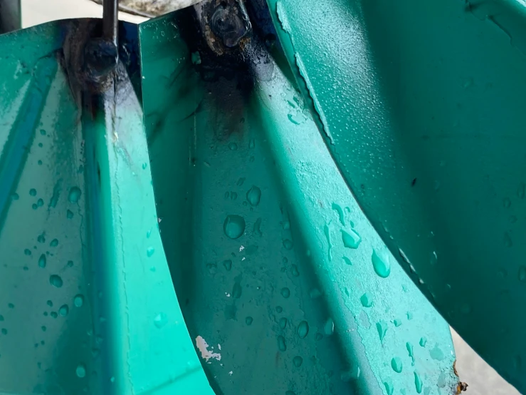 the bottom part of a green structure with water droplets