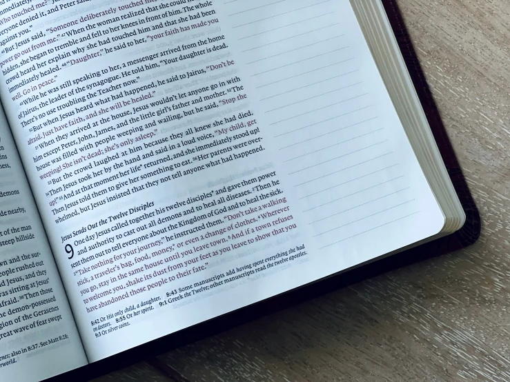 an open book sitting on top of a wooden table