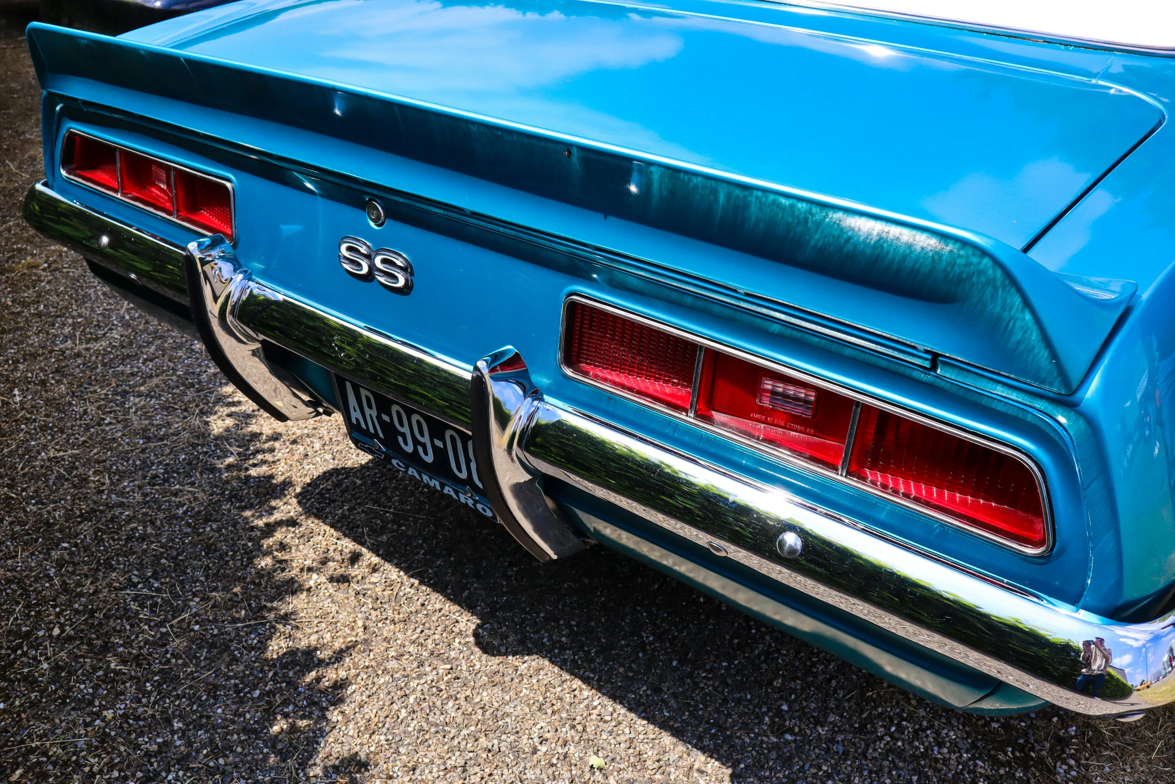 a blue car parked with another car behind it