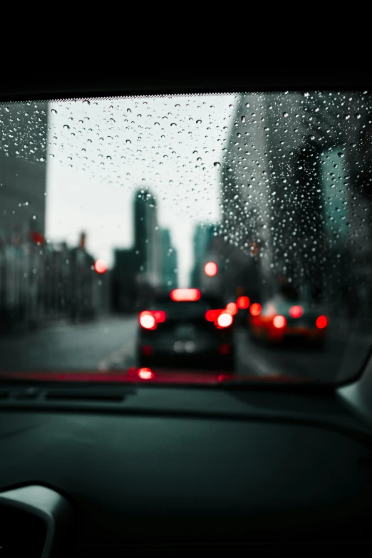 a car driving on a road with a building in the background