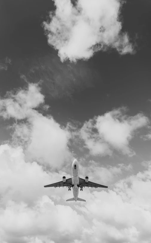 an airplane flying overhead with the wings extended