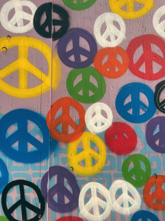 painted peace symbols are displayed on the wall