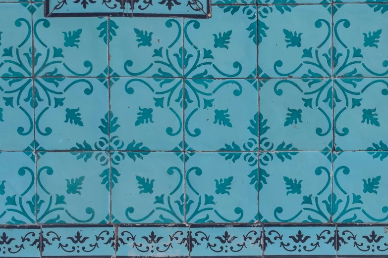 the blue tile has small designs on it