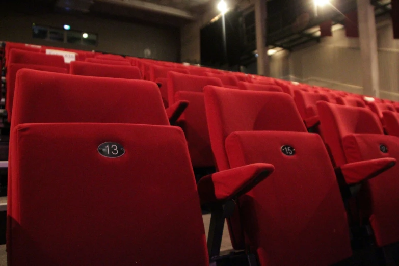 red chairs sit in a theater or theatre hall