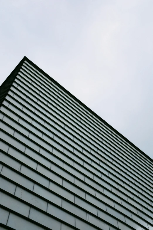 a clock sits below the side of a building