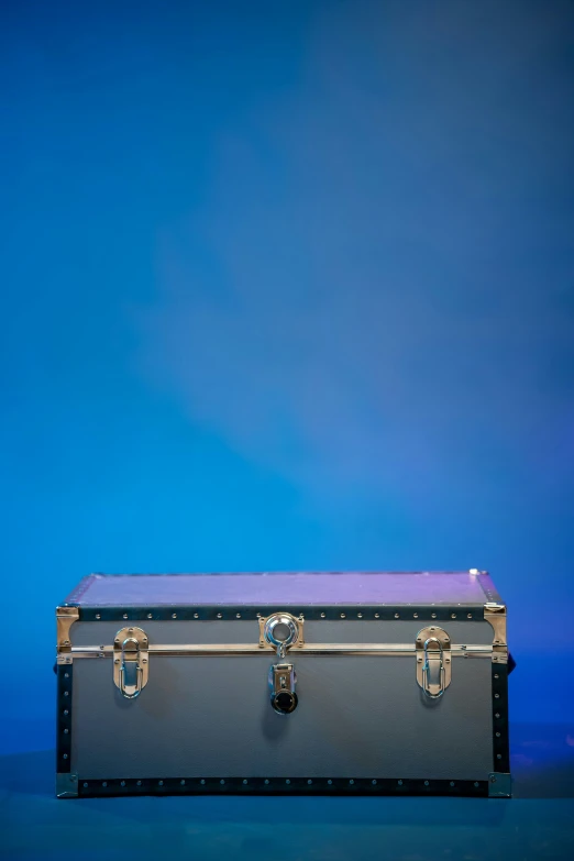 a metallic suitcase with double handles is shown