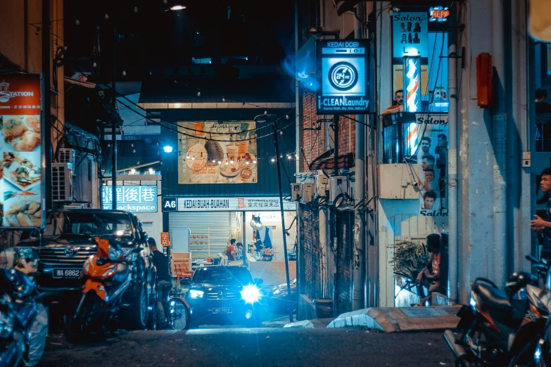 many motorcycles are parked on a street at night