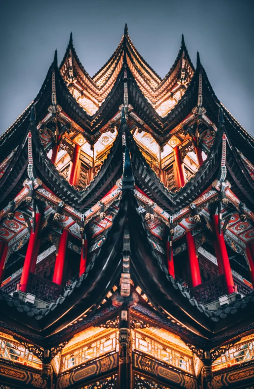 the architecture of a pagoda tower with red and gold accents