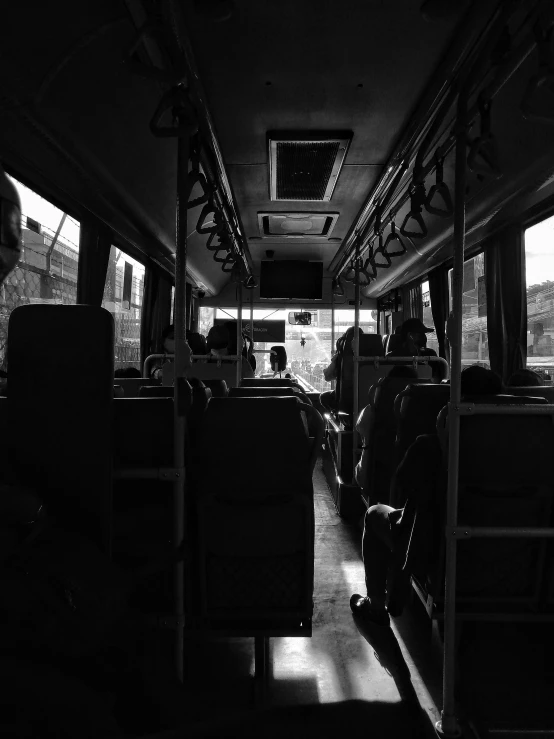 the inside of a bus with some people on it