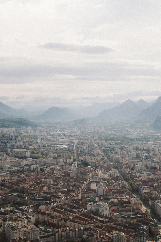 cityscape taken from high in the sky, with mountains in background