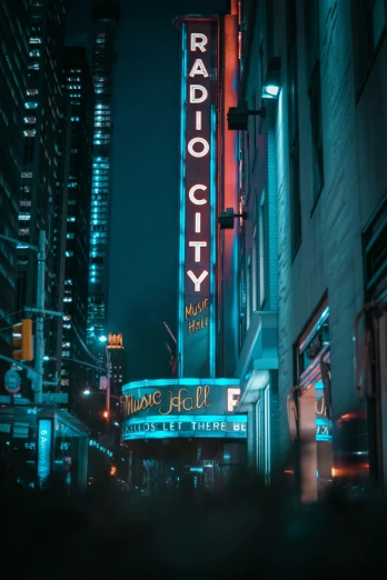 a theater sign that is lit up on the side of a building